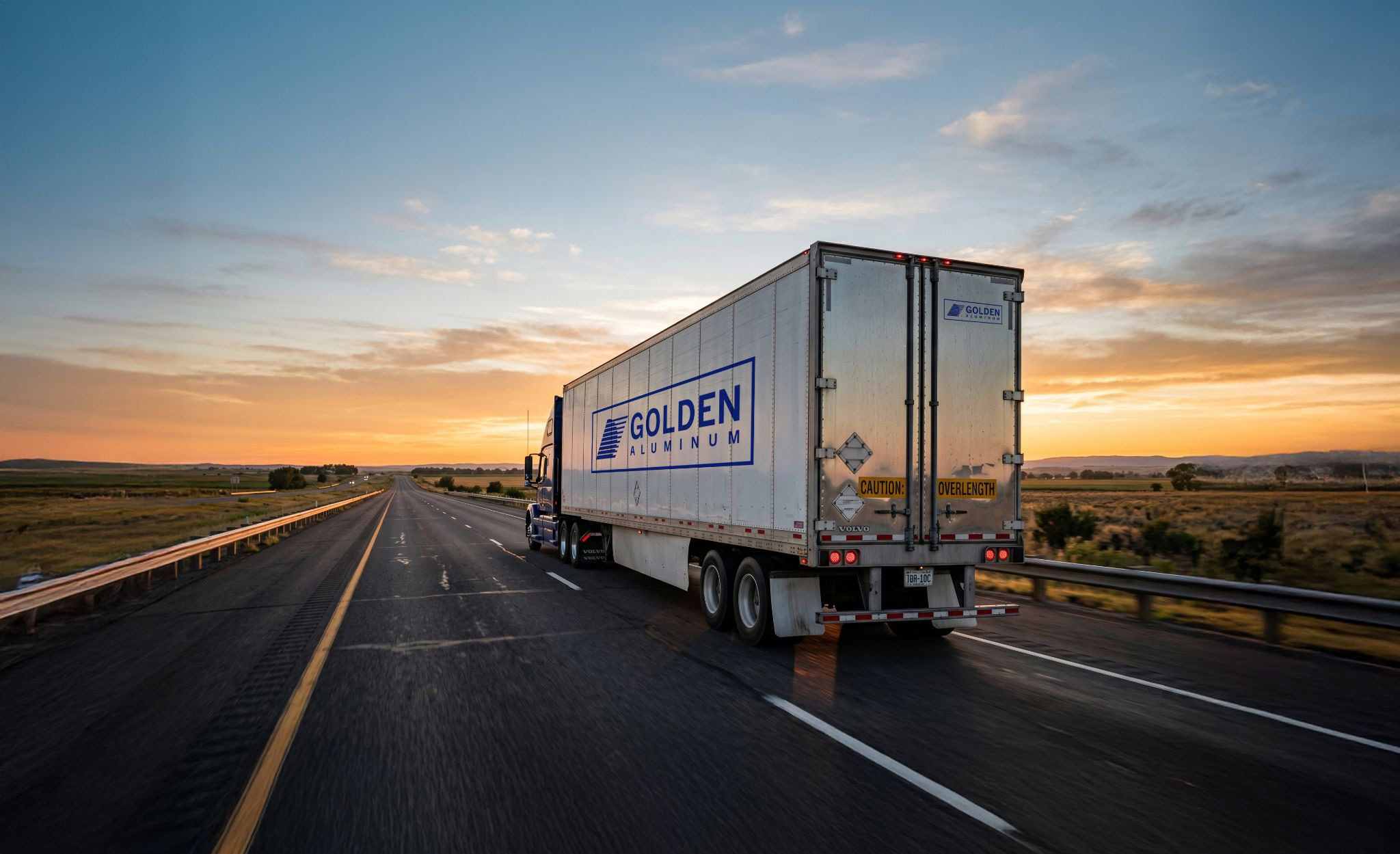Golden Aluminum delivery truck on a U.S. highway representing domestic aluminum shipping.